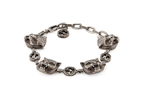 gucci silver feline head bracelet.